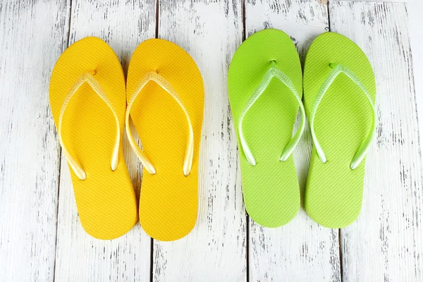 Colorful flip-flops on wooden background — Stock Photo, Image