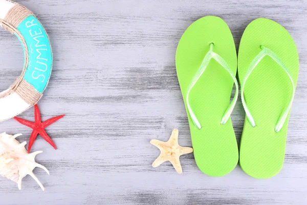 Bright flip-flops on color wooden background — Stock Photo, Image