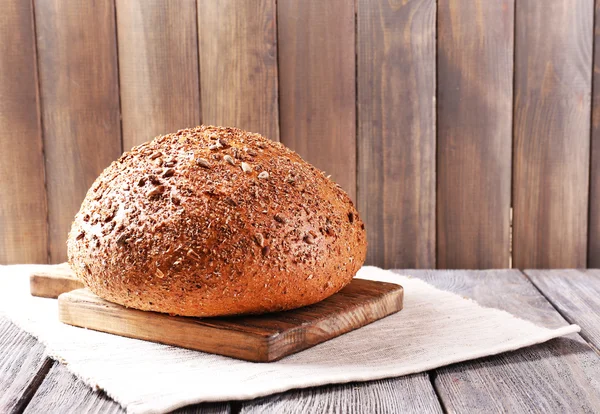 Fresh bread on wooden table — Stock Photo, Image