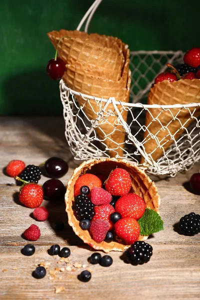 Different ripe berries in sugar cone — Stock Photo, Image