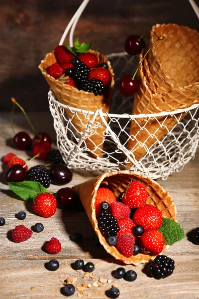 Different ripe berries in sugar cone — Stock Photo, Image