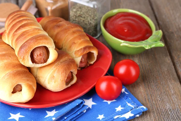 Baked sausage rolls on plate — Stock Photo, Image