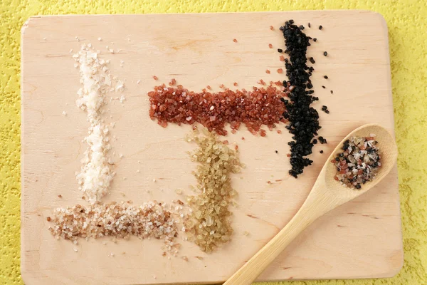 Sea salt on wooden board — Stock Photo, Image