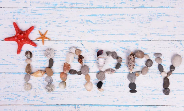 Word happy made from sea shells — Stock Photo, Image