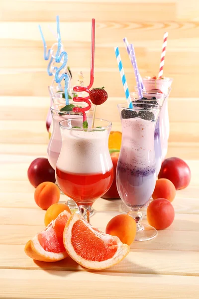 Delicious milkshakes on wooden table — Stock Photo, Image