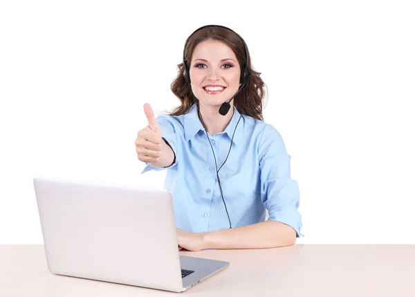 Young woman with headset sitting at table with notebook in room — Stock Photo, Image