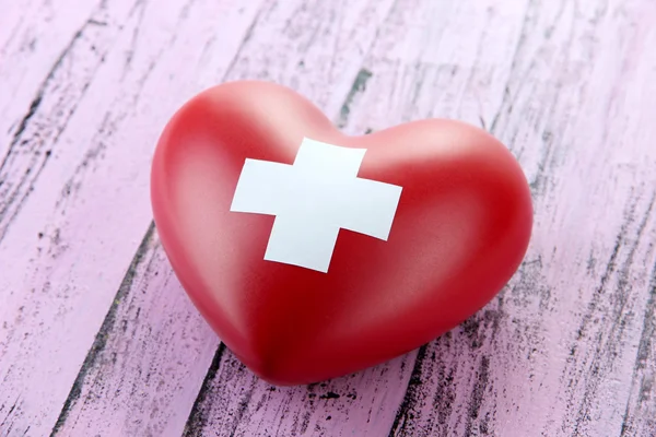 Red heart with cross sign — Stock Photo, Image