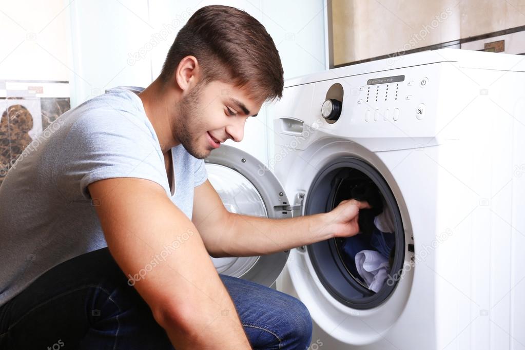 Man with washing machine — Stock Photo © belchonock 50020399