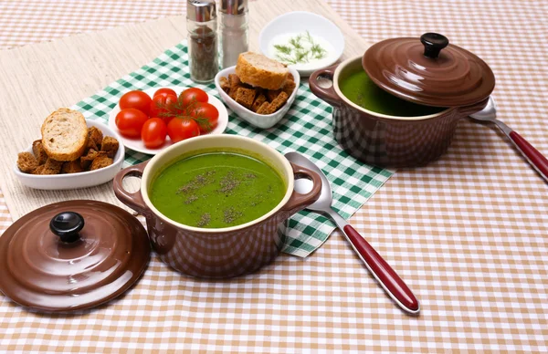 Tasty soup in saucepans on tablecloth, close up — Stock Photo, Image