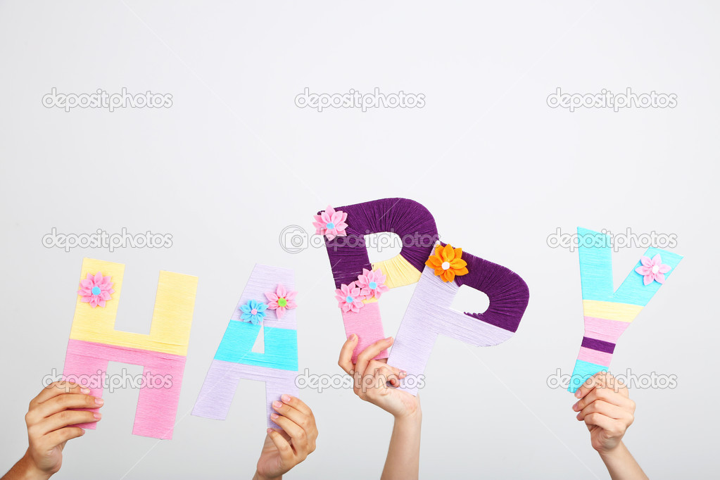 Hands holding up letters