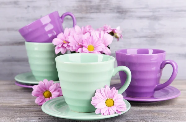 Cups and saucers with flowers — Stock Photo, Image