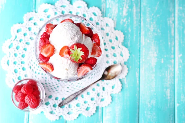 Creamy ice cream with raspberries on plate in glass bowl, on color wooden background — Stock Photo, Image