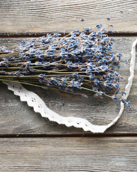 Lavender flowers on color wooden background — Stock Photo, Image