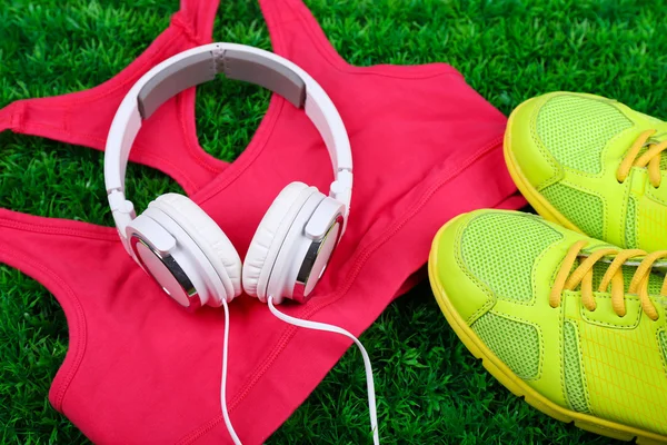 Sport clothes with shoes and headphones — Stock Photo, Image