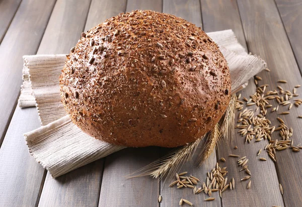 Fresh bread on wooden table — Stock Photo, Image