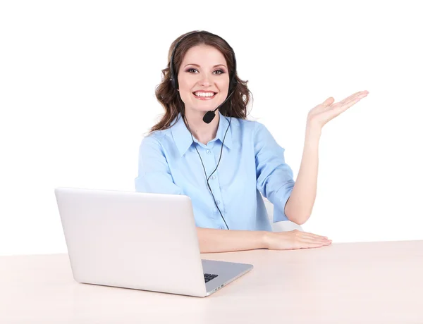 Young woman with headset sitting at table with notebook in room — Stock Photo, Image