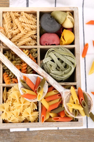 Colorful pasta in wooden box — Stock Photo, Image