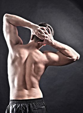 yakışıklı genç kaslı sporcu, koyu arka plan üzerinde