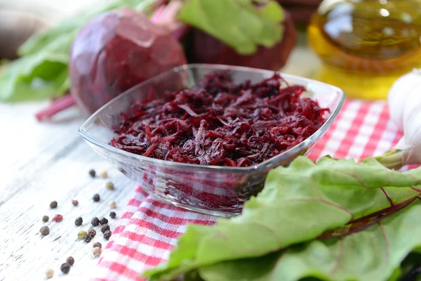 Grated beetroots in bowl — Stock Photo, Image