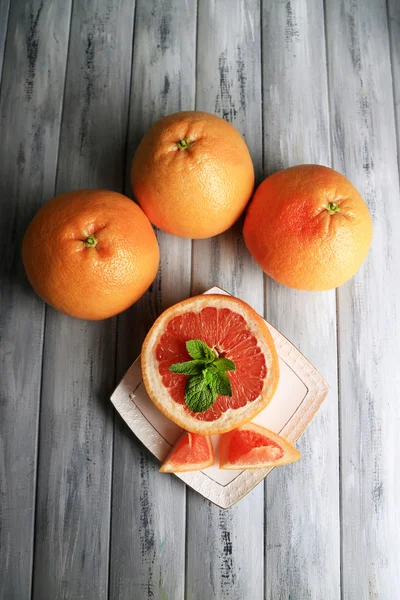 Zralých grapefruitů na štítku na barevné dřevěné pozadí — Stock fotografie