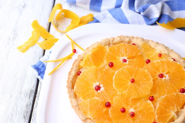 Homemade orange tart on plate, on color wooden background — Stock Photo, Image