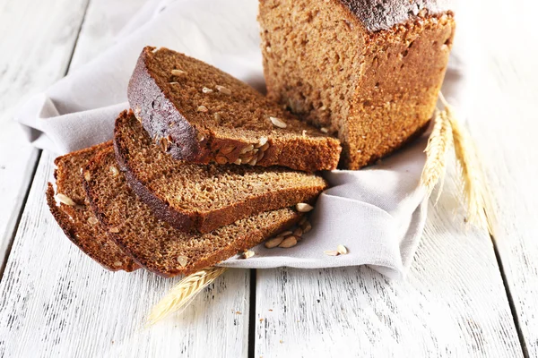 Fresh bread on wooden table — Stock Photo, Image