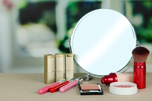 Round table mirror with cosmetics — Stock Photo, Image