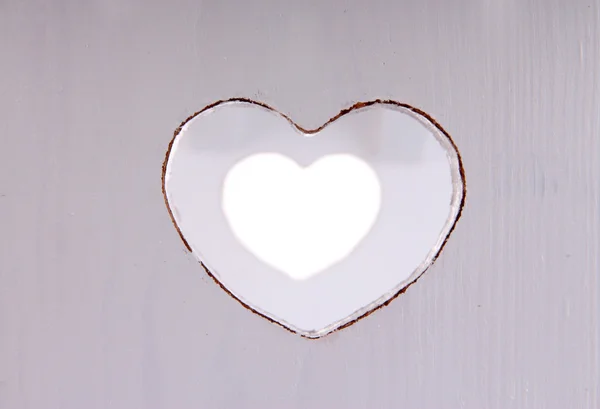Wooden board with heart shaped window — Stock Photo, Image