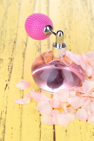 Perfume bottle with petals — Stock Photo, Image