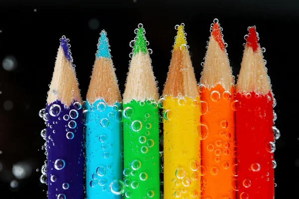 Colorful pencils in water bubbles — Stock Photo, Image