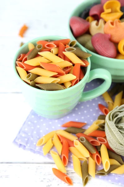 Colorful pasta in color bowls — Stock Photo, Image