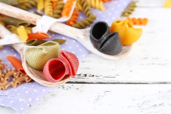 Colorful pasta in wooden spoons — Stock Photo, Image