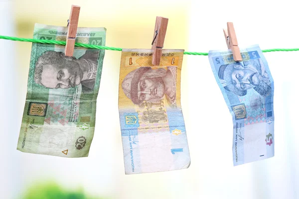 Ukrainian hryvnia bills hanging on rope — Stock Photo, Image