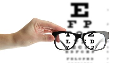 Reading eyeglasses in hand and eye chart clipart