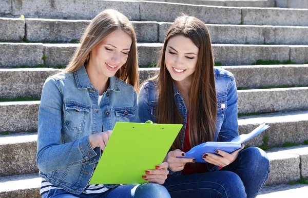 Students sitting on stairs — Stock Photo, Image