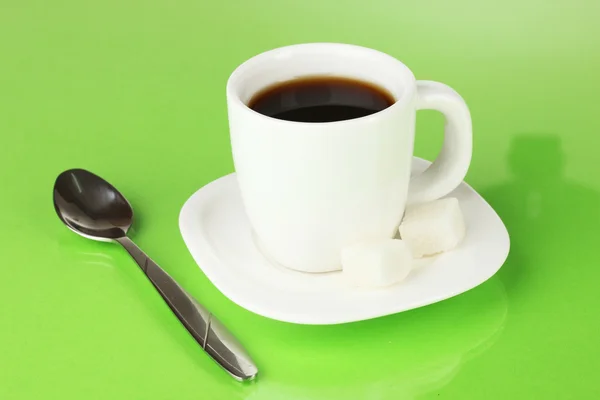 A cup of strong coffee on green background — Stock Photo, Image