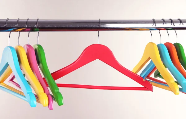 Colorful clothes hangers on gray background — Stock Photo, Image