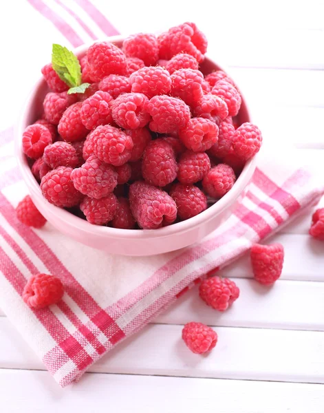 Ripe sweet raspberries in bowl on table close-up — Stock Photo, Image