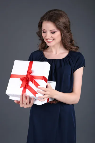 Beautiful young girl in dress with on grey background — Stock Photo, Image