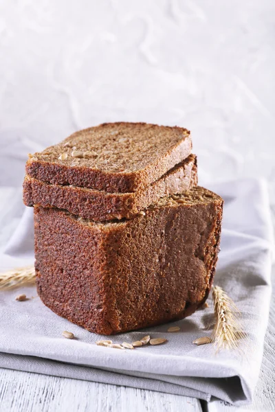 Fresh bread on wooden table — Stock Photo, Image