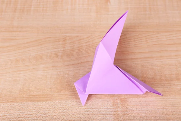 Origami bird on wooden table, close up — Stock Photo, Image