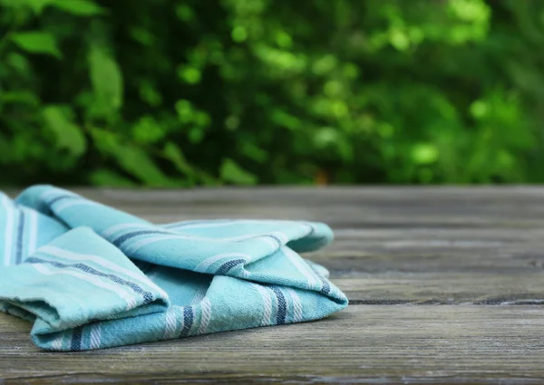 Wooden table with tablecloth — Stock Photo, Image