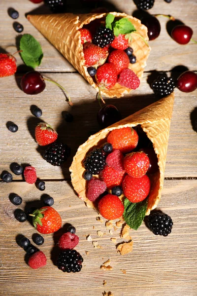 Different ripe berries in sugar cones — Stock Photo, Image