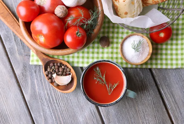 Hemlagad tomatsaft i färg mugg, bröd pinnar, kryddor och färska tomater på trä bakgrund — Stockfoto