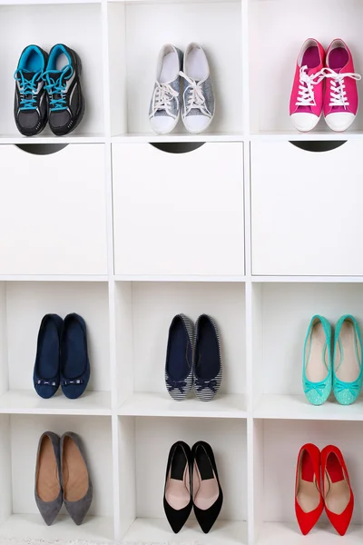 Colorful shoes on wooden shelves — Stock Photo, Image
