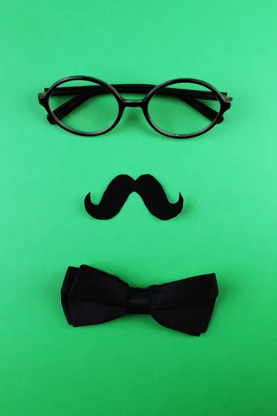 Glasses, mustache and bow tie forming man face — Stock Photo, Image