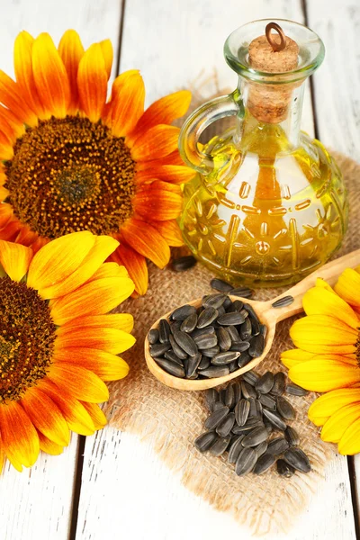 Sunflowers with oil and seeds — Stock Photo, Image