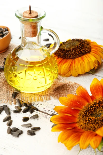 Sunflowers with oil and seeds — Stock Photo, Image