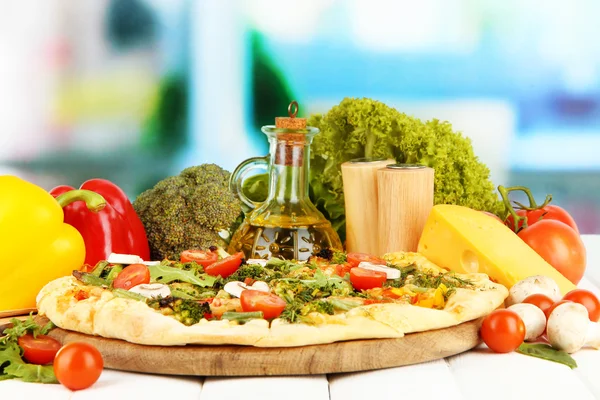 Sabrosa pizza vegetariana y verduras en mesa de madera — Foto de Stock