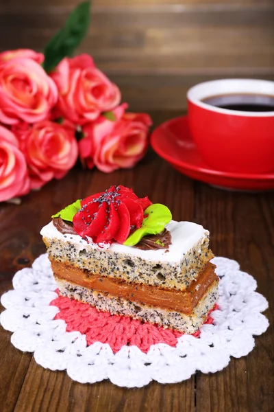 Bolo saboroso na mesa no fundo de madeira — Fotografia de Stock